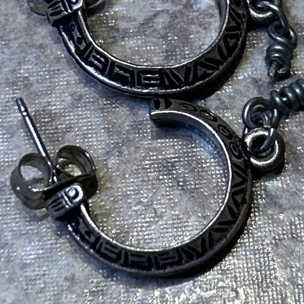 Vintage artisan-style silver hoop earrings (unmarked) with etched geo design